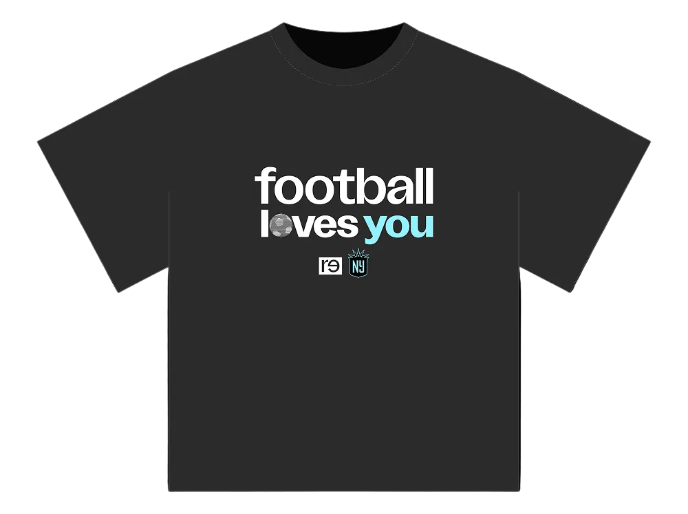 A dark charcoal gray t-shirt displayed flat against a solid black background. The front of the shirt features a graphic print reading 'football loves you' in white and light blue lettering, with small social media and club crest icons underneath.